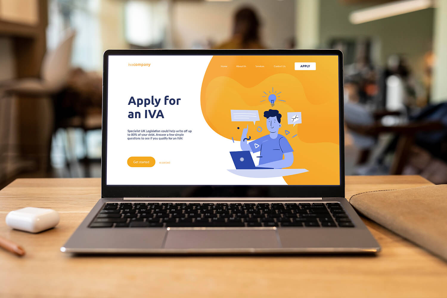 A laptop with an 'Apply for an IVA' landing page.